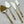 Aiza Stainless Steel Cheese Knife Set featuring four elegant brass-toned knives with polished handles and precision-crafted blades, perfect for sophisticated dining.