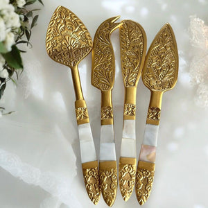 Elegant stainless steel cheese knife set with brass detailing and Mother of Pearl inlays, perfect for stylish entertaining.