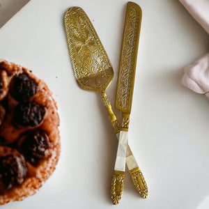 Intricate Záhra Naqashi Cake Server Set with detailed floral engravings, displayed next to a delicious tart.