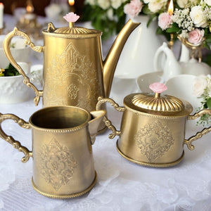 Elegant vintage brass tea set, featuring a meticulously handcrafted 3-piece ensemble. Includes a kettle, milk pot, and sugar pot, adorned with intricate antique designs